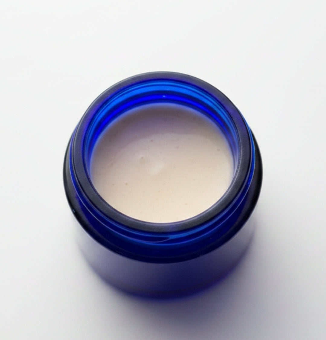 Cream jar labeled Ageless Facial Balm by 4Mindful Organic LLC, featuring a smooth, natural skincare product for health and wellness.