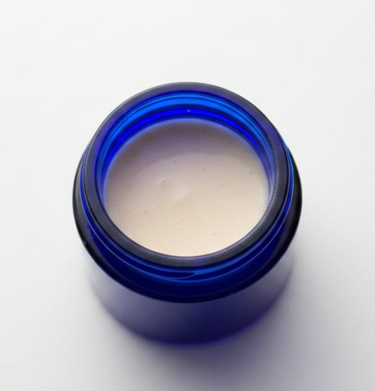Cream jar labeled Ageless Facial Balm by 4Mindful Organic LLC, featuring a smooth, natural skincare product for health and wellness.
